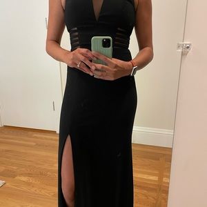 Black evening gown with dramatic neckline and mesh cutouts